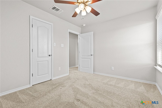 unfurnished bedroom featuring ceiling fan and carpet flooring