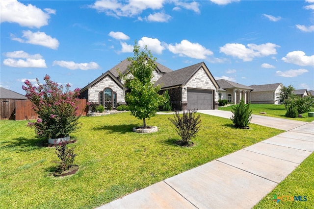 view of front of home with a garage and a front yard