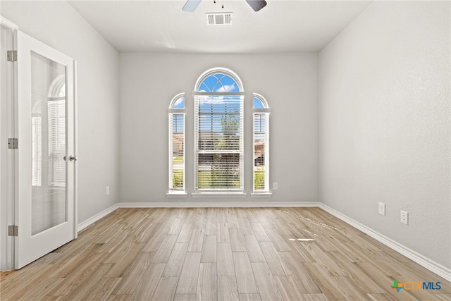 empty room with light hardwood / wood-style floors and ceiling fan