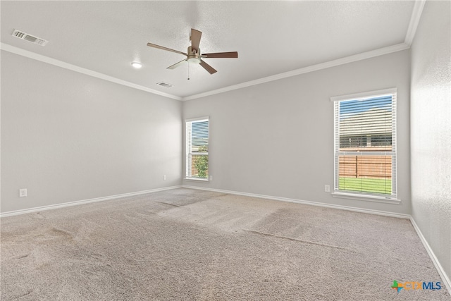 empty room featuring ornamental molding, ceiling fan, and carpet floors