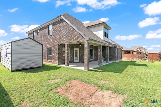 rear view of property featuring a playground, a shed, a patio, and a yard