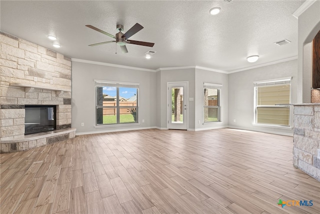 unfurnished living room with ceiling fan, a textured ceiling, and light hardwood / wood-style flooring