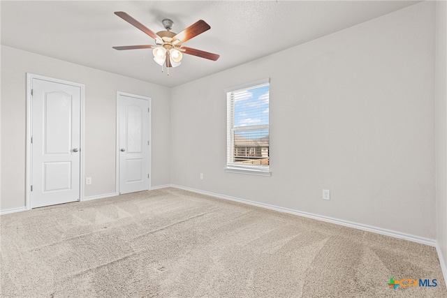 unfurnished bedroom with carpet flooring and ceiling fan