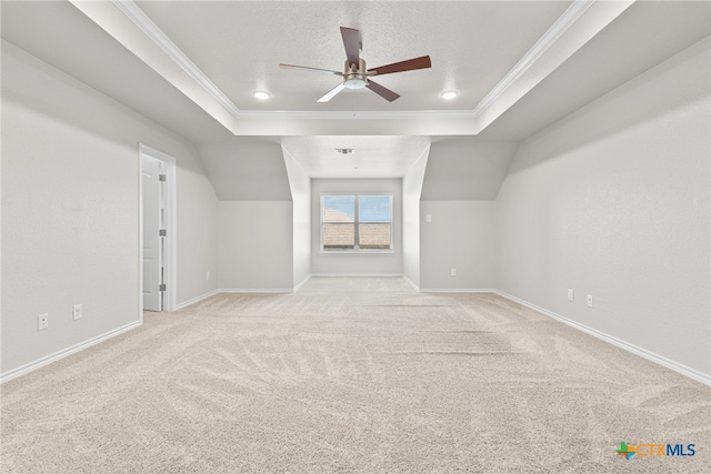 additional living space with a textured ceiling, light carpet, and ceiling fan