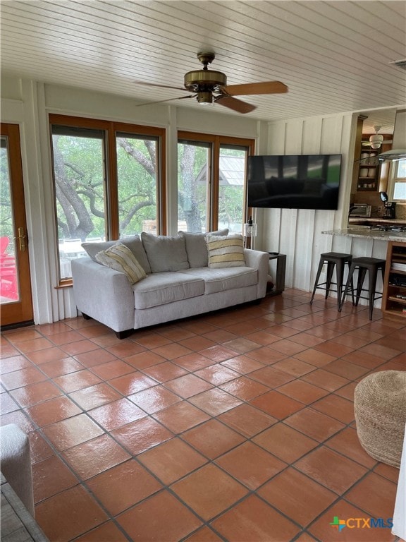 tiled living room with ceiling fan