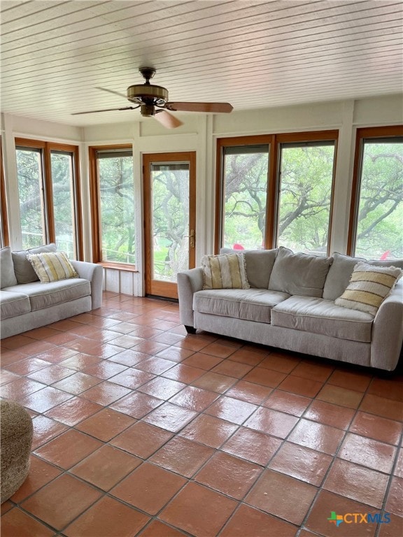 tiled living room with ceiling fan