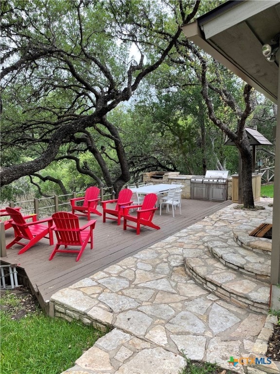 view of patio featuring a wooden deck and an outdoor fire pit