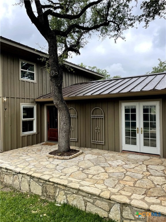 property entrance with a patio and french doors