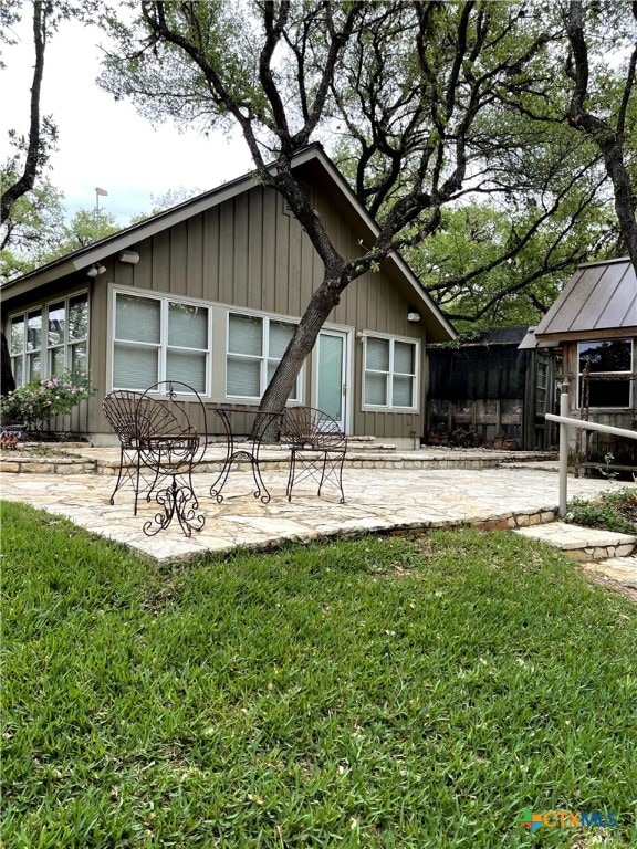 rear view of house with a patio, a lawn, and a gazebo