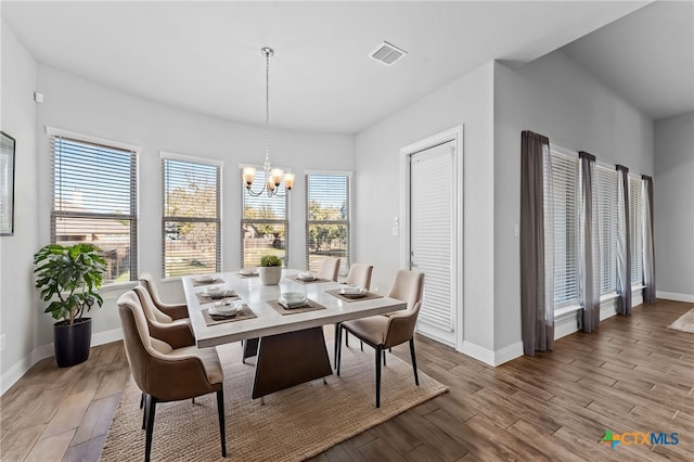 dining room featuring light hardwood / wood-style floors and a notable chandelier