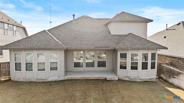 back of property with a patio and a lawn