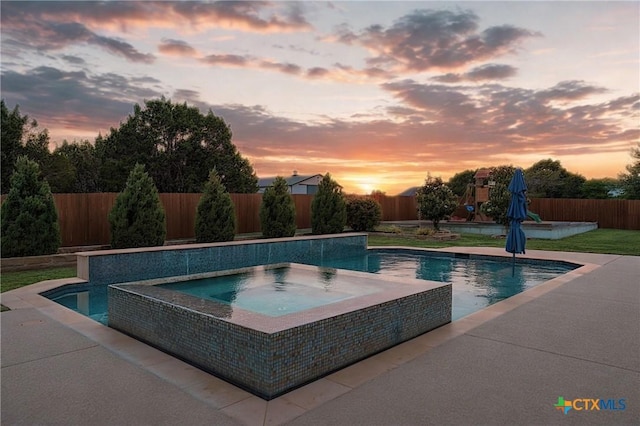 view of pool featuring an in ground hot tub, a fenced in pool, a fenced backyard, and a patio area