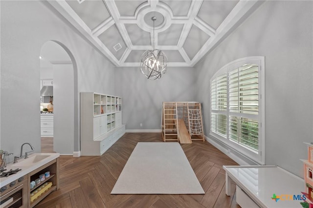 dining area featuring an inviting chandelier, arched walkways, coffered ceiling, and high vaulted ceiling