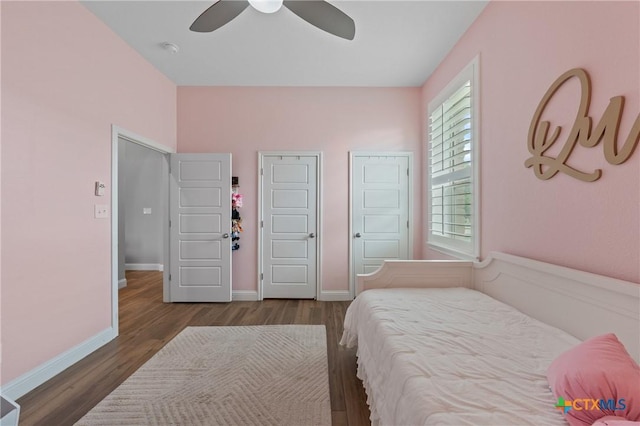 bedroom featuring a ceiling fan, baseboards, and wood finished floors