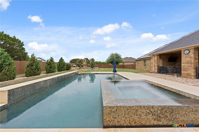 view of pool with an in ground hot tub, a fenced in pool, and a fenced backyard