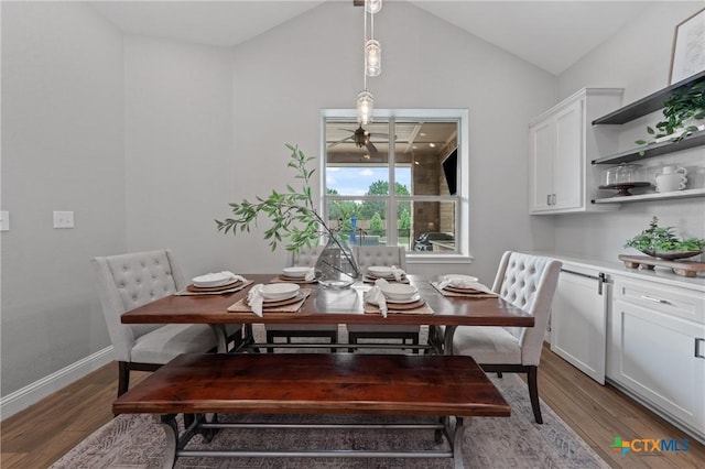 dining room with baseboards, ceiling fan, vaulted ceiling, and wood finished floors