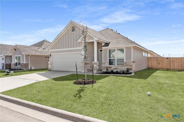 craftsman-style home with driveway, fence, a front lawn, and board and batten siding