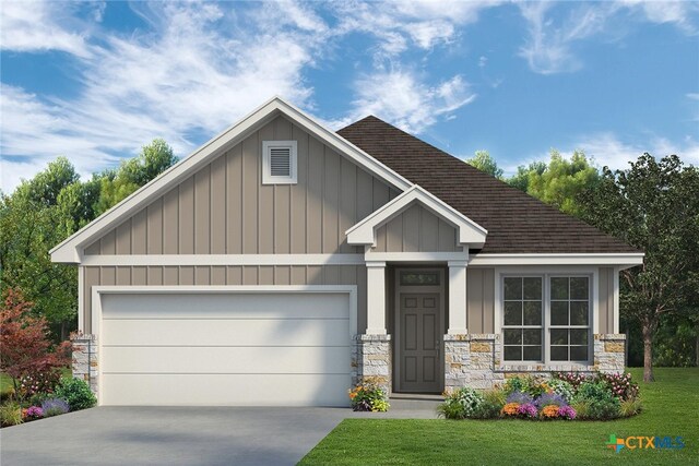 craftsman house with a front yard and a garage