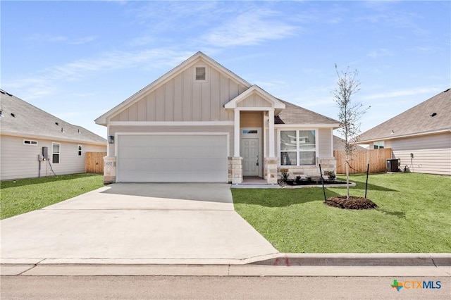 craftsman-style house featuring board and batten siding, a front yard, cooling unit, a garage, and driveway