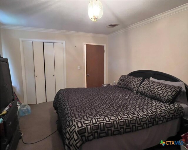 bedroom featuring carpet, a closet, and crown molding