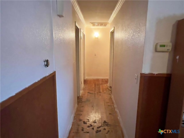 corridor featuring light hardwood / wood-style floors and ornamental molding