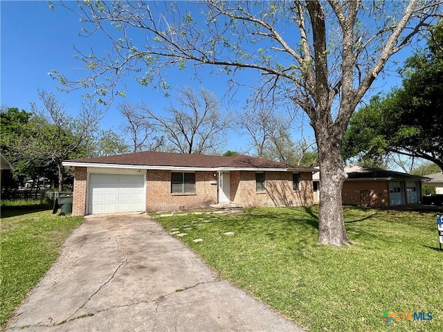 1504 E Central Ave, Temple, TX 76501 - ranch-style house with a garage, a front yard, brick siding, and driveway