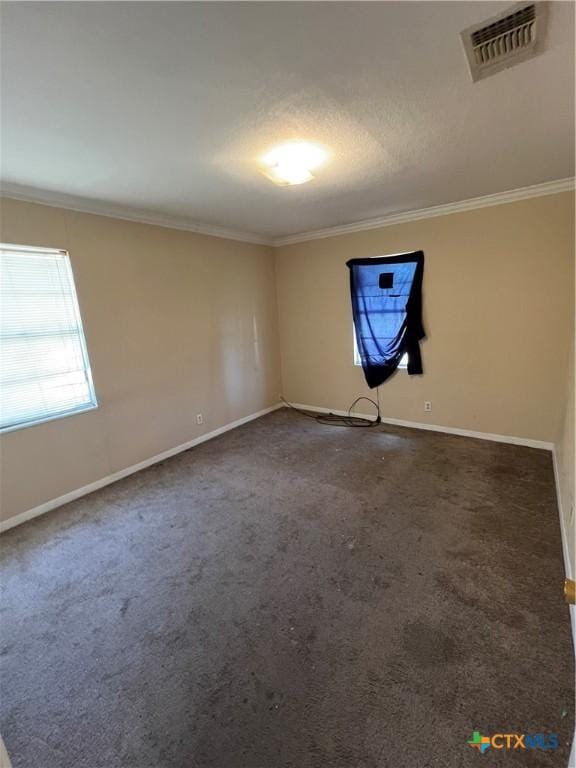 1504 E Central Ave, Temple, TX 76501 - unfurnished room featuring visible vents, baseboards, ornamental molding, and carpet floors