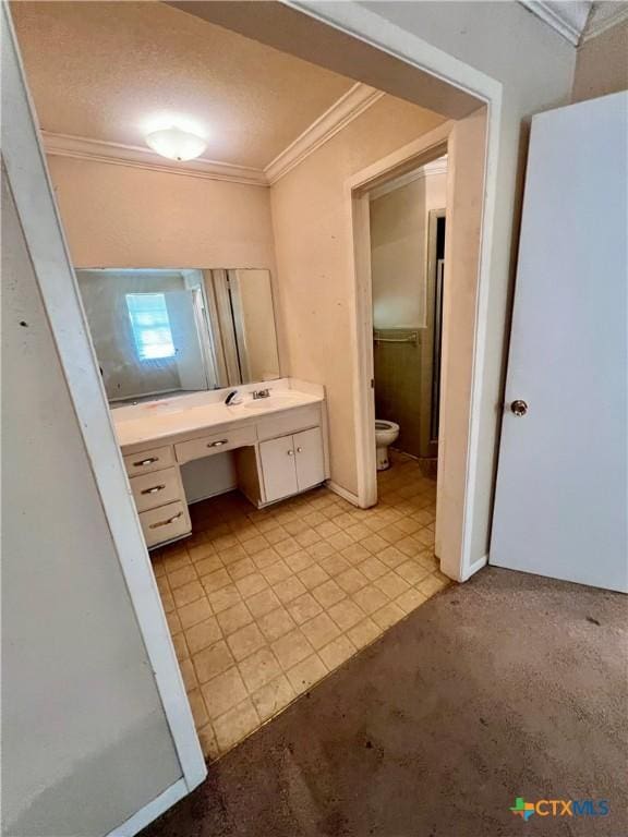 1504 E Central Ave, Temple, TX 76501 - bathroom featuring vanity, ornamental molding, and toilet