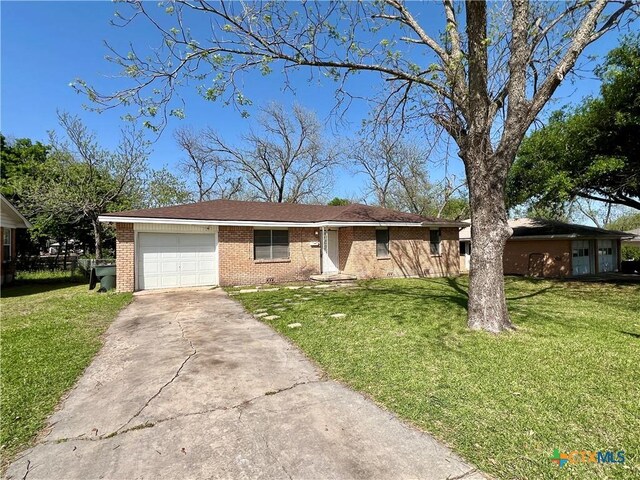 1504 E Central Ave, Temple, TX 76501 - ranch-style home featuring an attached garage, concrete driveway, a front lawn, and brick siding