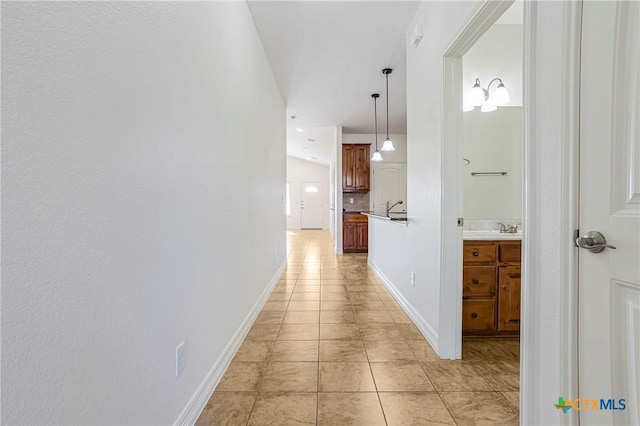 1108 Indian Mallow Dr, Temple, TX 76502 - hallway featuring baseboards, a sink, and light tile patterned flooring