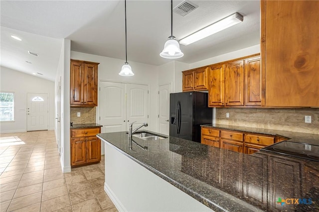 1108 Indian Mallow Dr, Temple, TX 76502 - kitchen with brown cabinets, black fridge with ice dispenser, decorative backsplash, and a sink