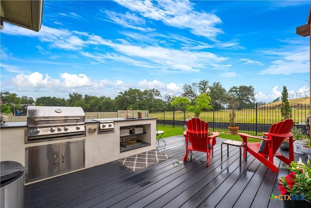 1235 Yaupon Loop, New Braunfels, TX 78132 - wooden terrace with an outdoor kitchen and a fenced backyard