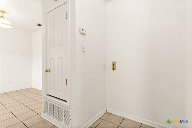 hall featuring light tile patterned floors