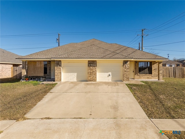 ranch-style home featuring a garage and a front lawn