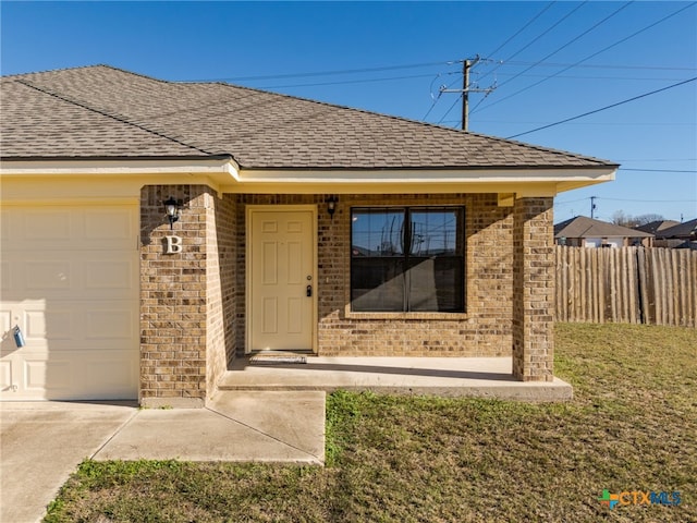 entrance to property with a lawn and a garage