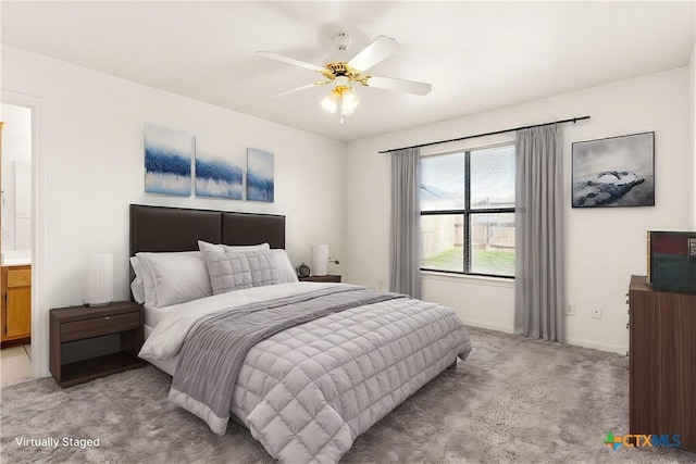 bedroom featuring ensuite bath, ceiling fan, and light colored carpet