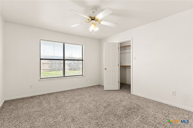 unfurnished bedroom featuring ceiling fan, a closet, and carpet floors