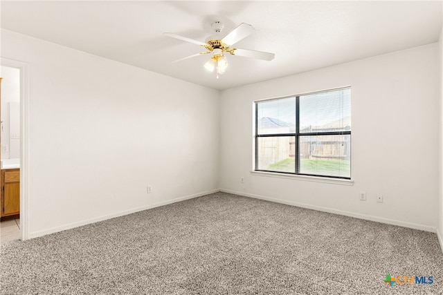 empty room with ceiling fan and light colored carpet