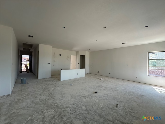 unfurnished living room featuring a wealth of natural light