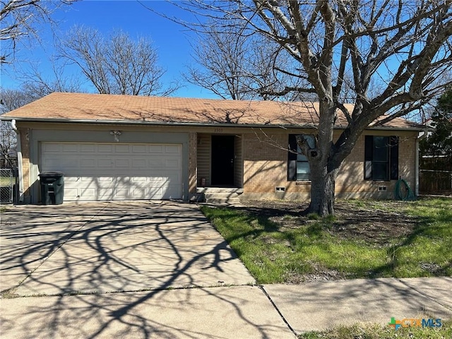 ranch-style house with brick siding, an attached garage, and driveway