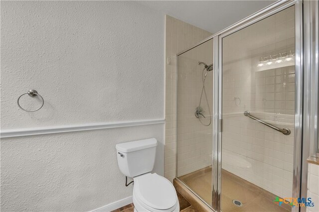 404 Oak St, Copperas Cove, TX 76522 - full bathroom featuring toilet, a stall shower, and a textured wall