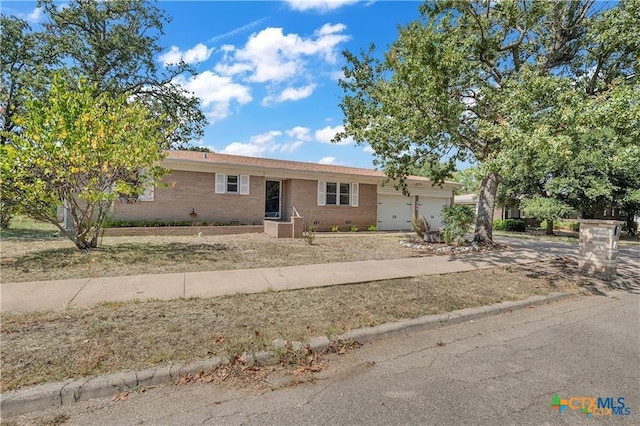 404 Oak St, Copperas Cove, TX 76522 - ranch-style home with an attached garage, driveway, and brick siding