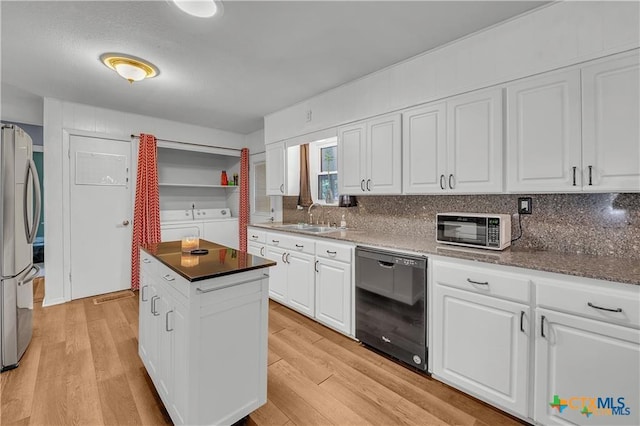 404 Oak St, Copperas Cove, TX 76522 - kitchen featuring dishwasher, freestanding refrigerator, washer and clothes dryer, a sink, and white cabinets