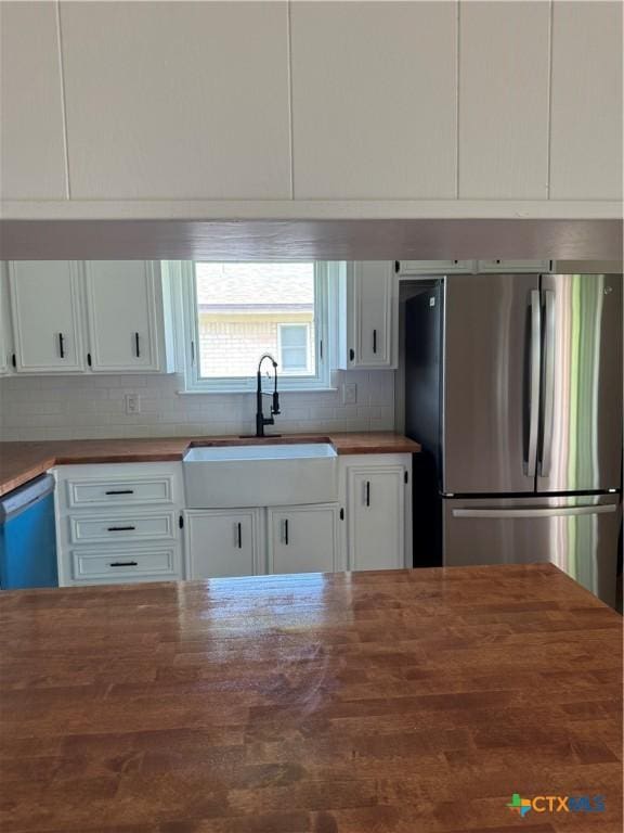 1508 Briar Ln, Killeen, TX 76543 - kitchen with wood counters, freestanding refrigerator, white cabinets, and tasteful backsplash