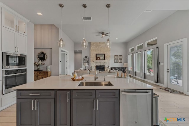 kitchen featuring gray cabinetry, ceiling fan, sink, stainless steel appliances, and white cabinets