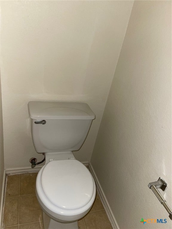 bathroom featuring toilet and tile patterned floors