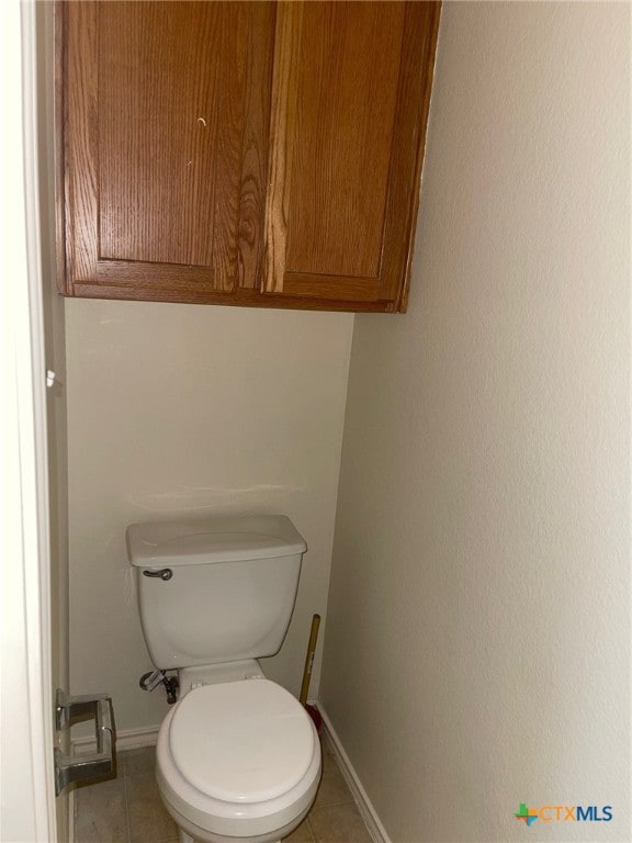 bathroom with toilet and tile patterned floors