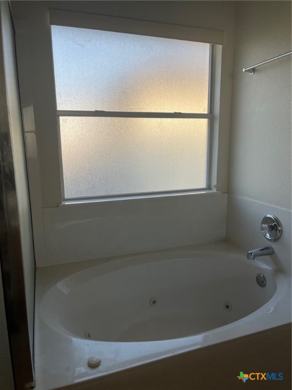 bathroom featuring a tub to relax in