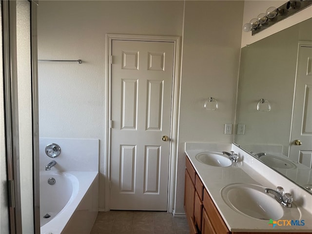 bathroom featuring vanity, a tub, and tile patterned floors