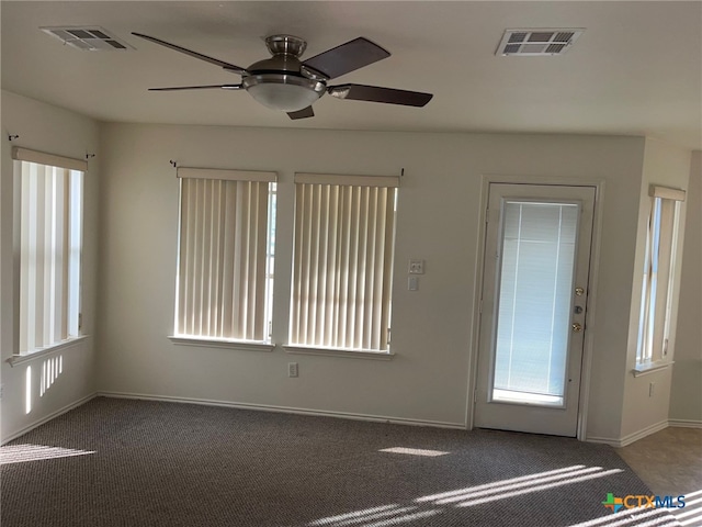 carpeted spare room with ceiling fan